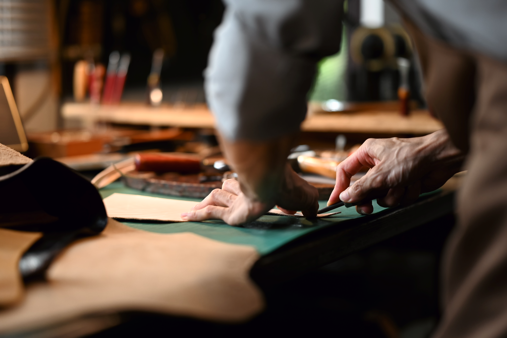 Craftsman shaping premium hunting gear materials — banner for Crafting the Hunt’s Future category, Fieldborne Gear.